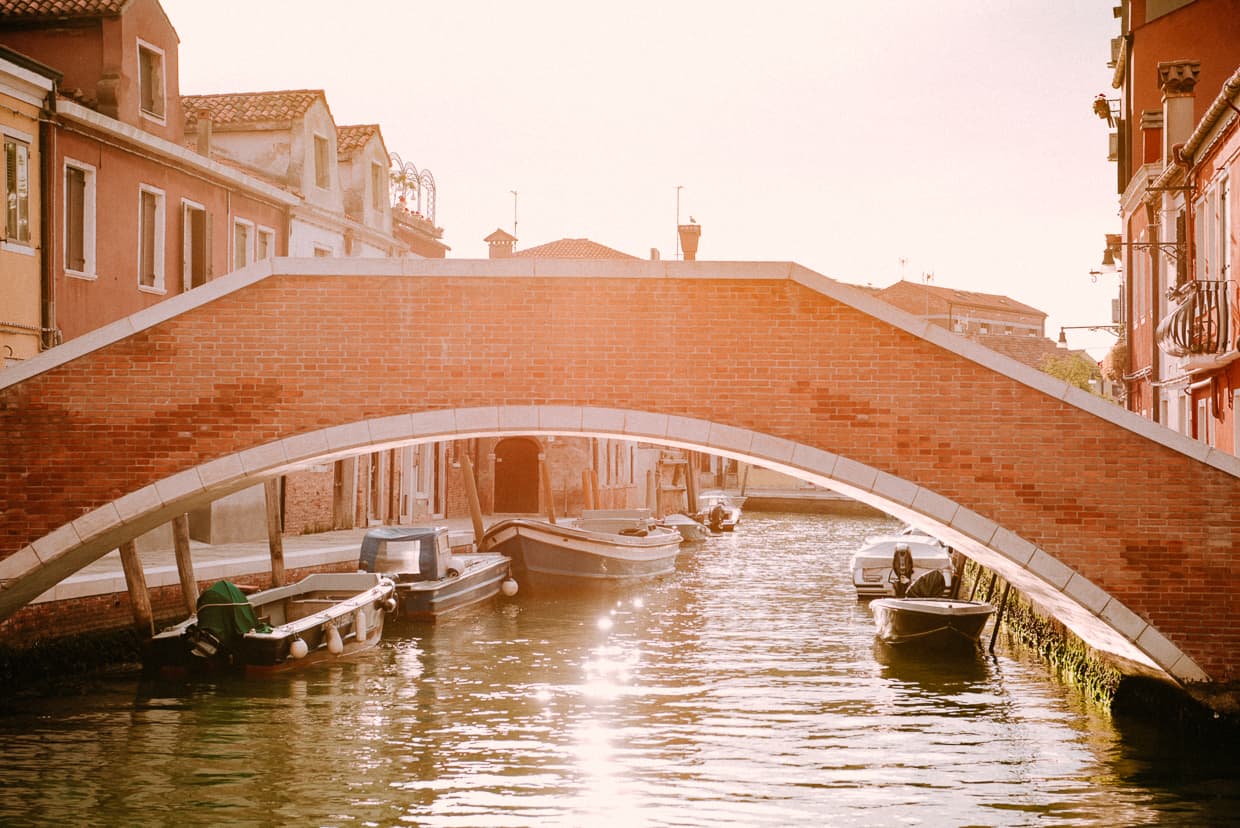 A bridge over a canal at sunrise on Murano near Venice, Italy.