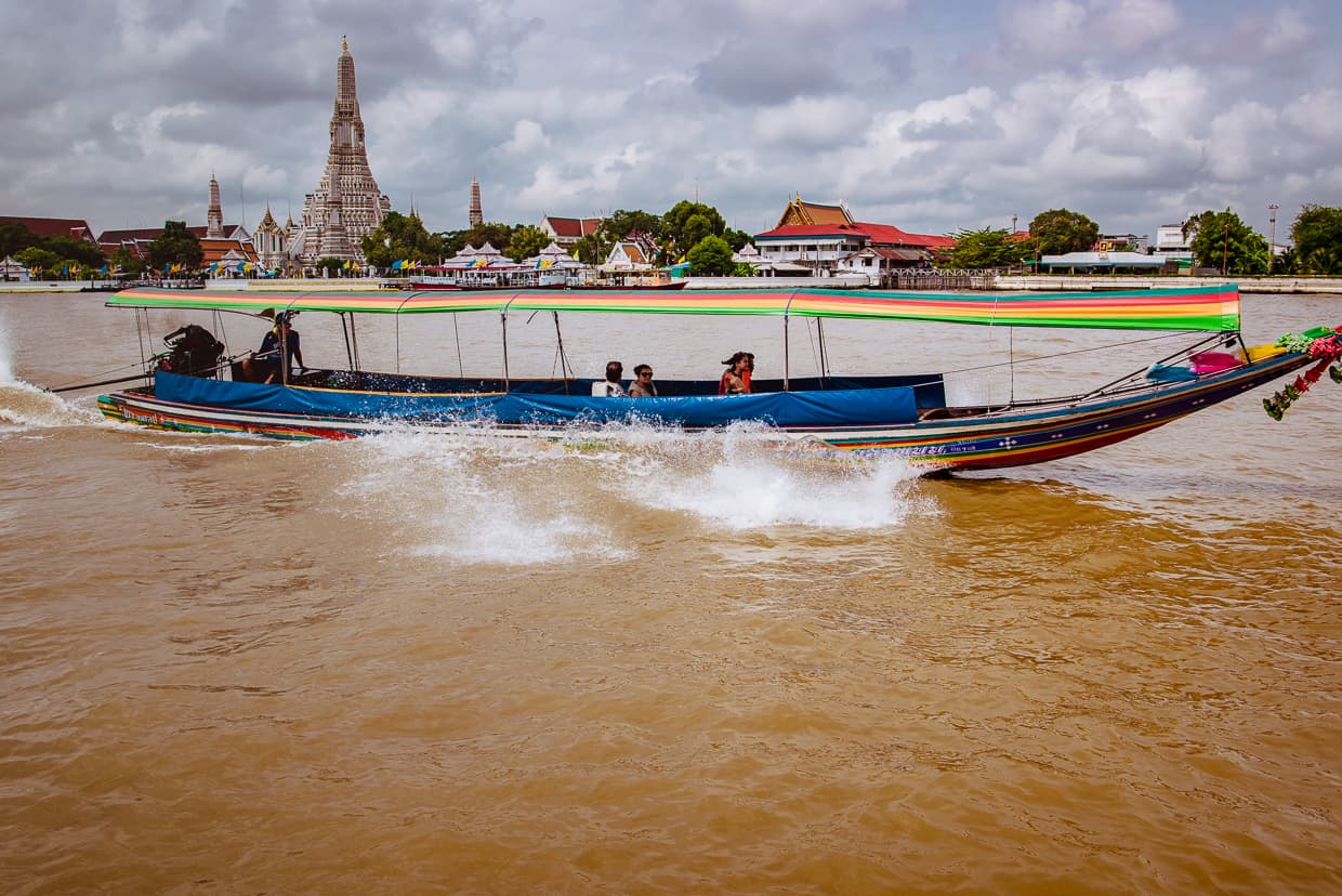 A boat on the river in front of Wat Arun.