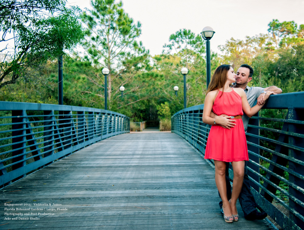Couple pauses while crossing a bridge at the Florida Botanical Gardens