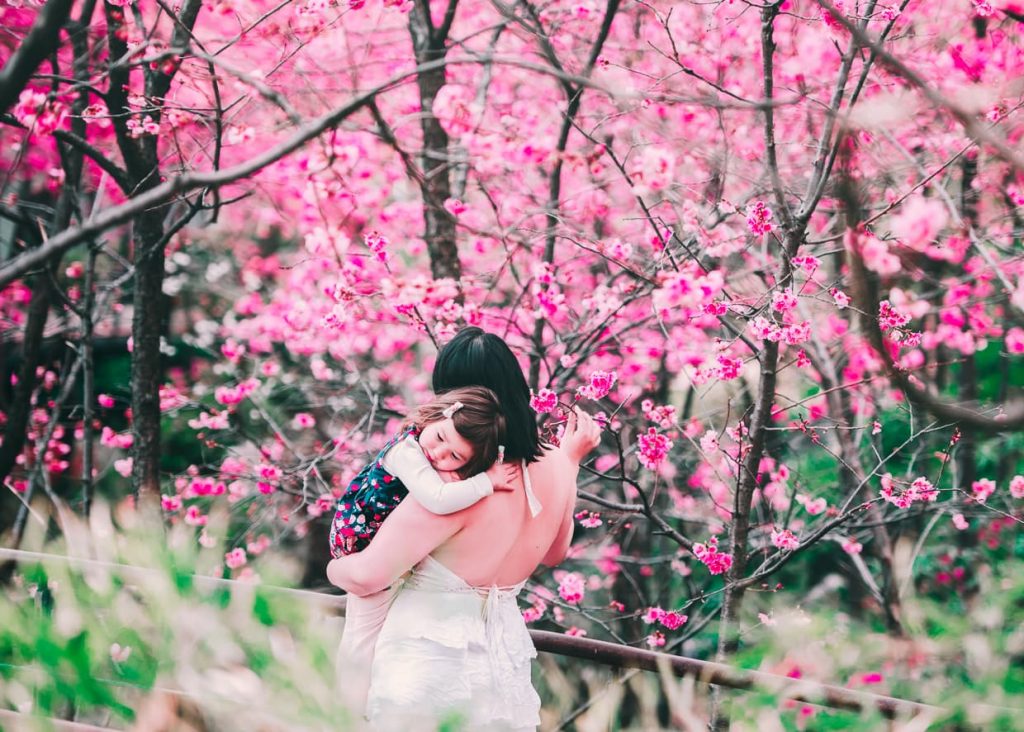 Mother and daughter with cherry blossoms in Dali, China.