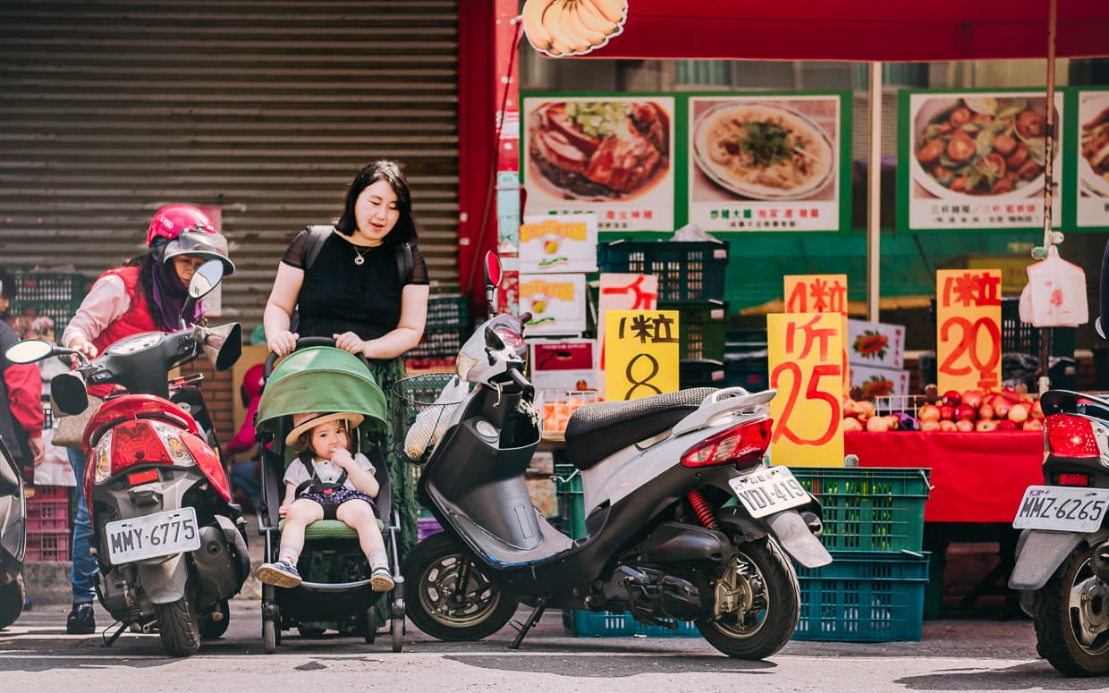 Pushing the Babyzen Yoyo Trael Stroller between motorcycles in Kaohsiung, Taiwan.