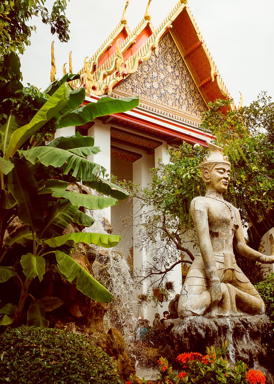 A statue in front of a temple at Wat Pho in Bangkok, Thailand.