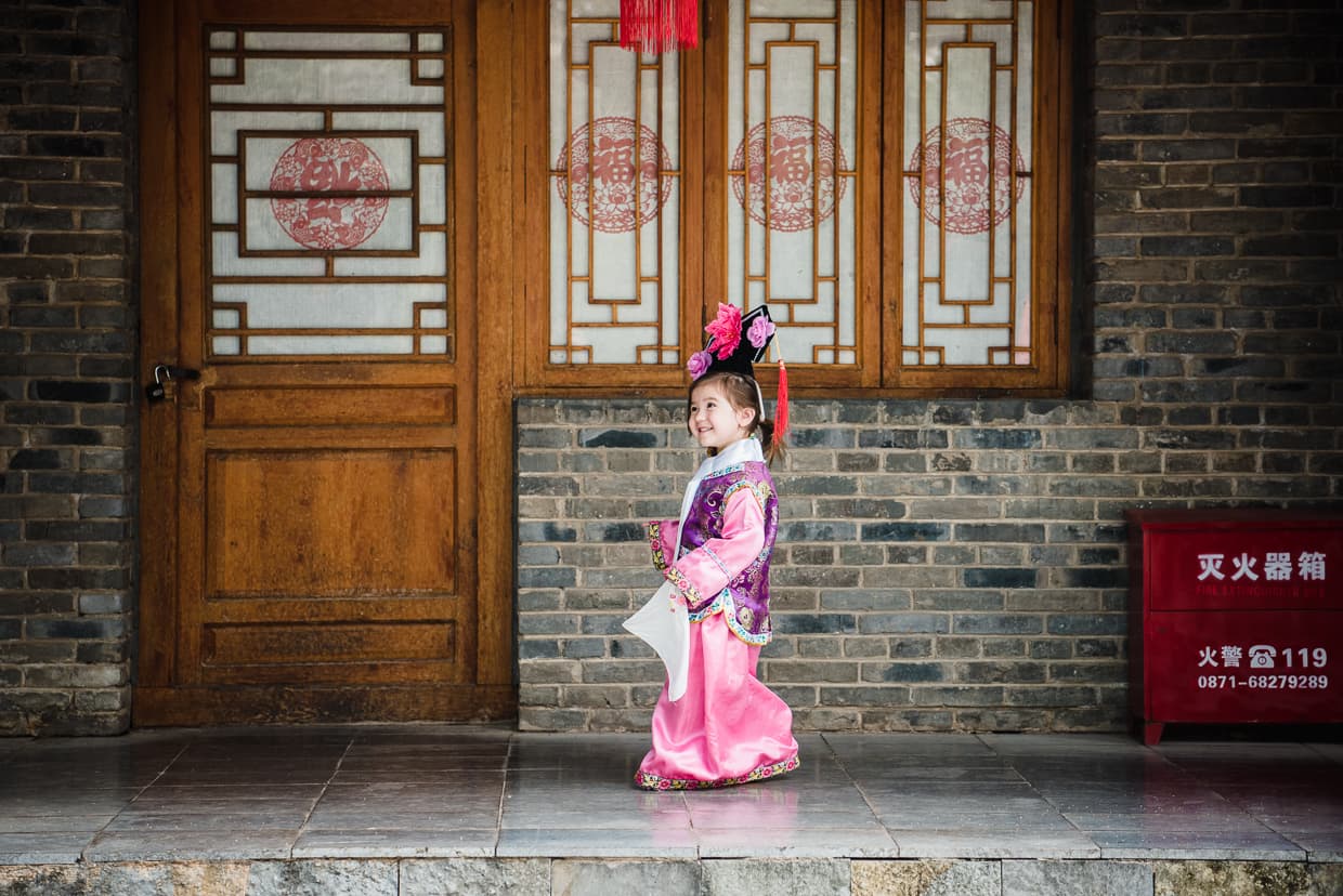 Lisa walking in Manchurian girl clothes in Kunming, China.