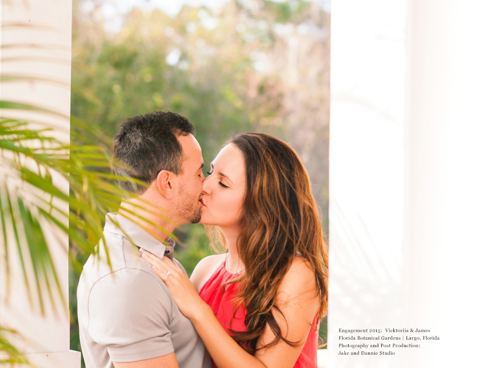 Couple kissing between white columns in Florida