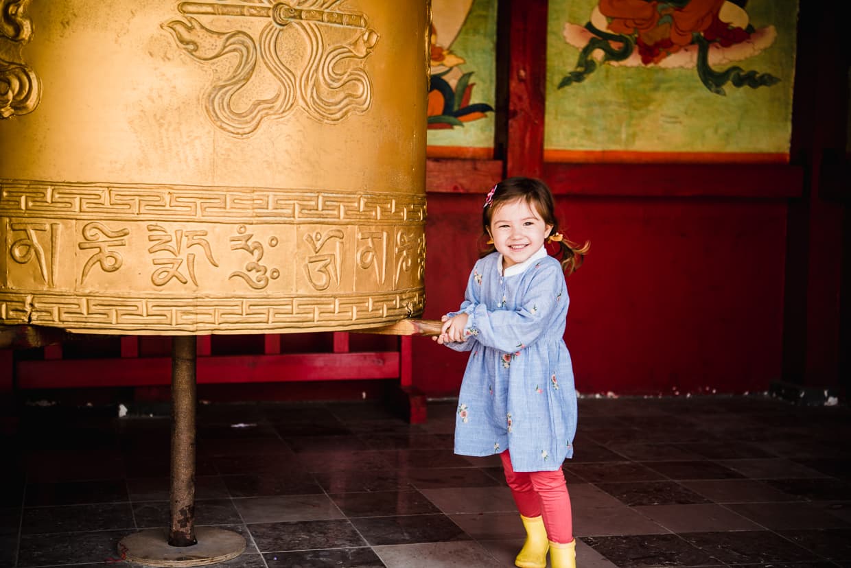 Child turning a Tibetan prayer wheel in the Yunnan Ethnic Village