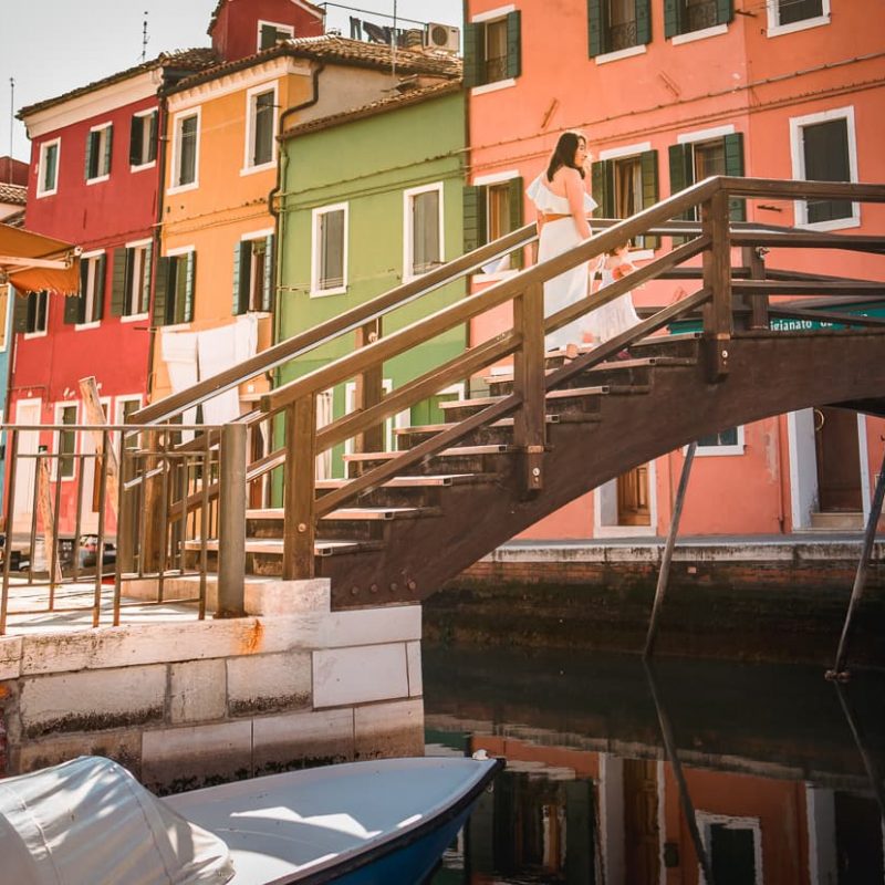 Walking over a bridge on the Venice Island of Burano in Italy