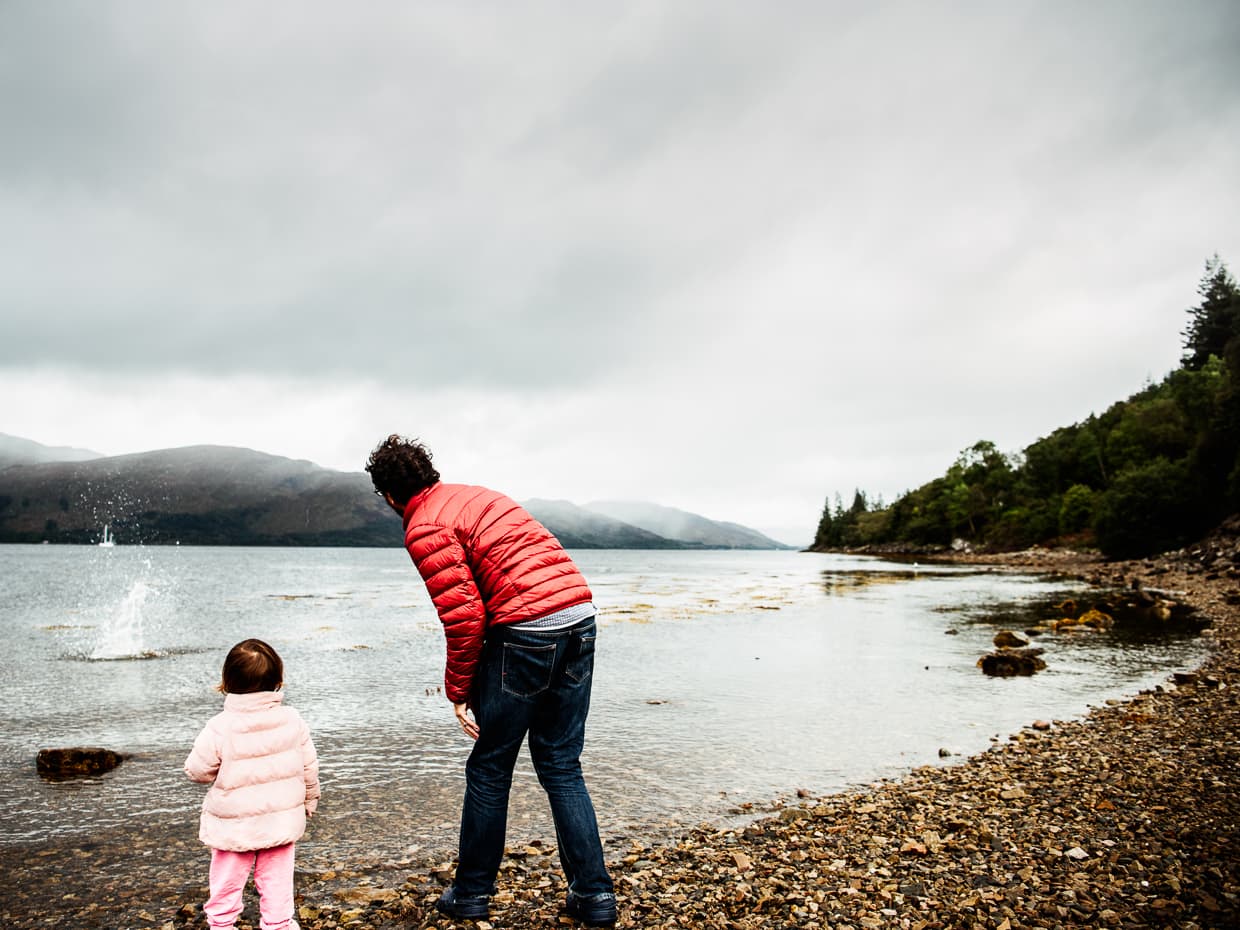 Jake and Lisa throwing stones into a Loch in Scotland