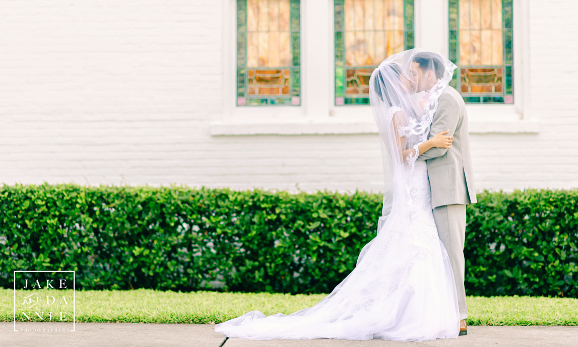 Bride and Groom Kiss in front of the White Chapel in Palm Harbor, Florida