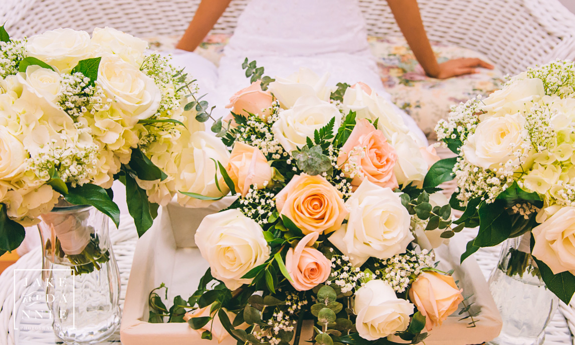 The flower bouquets laid out on a table in front of the bride