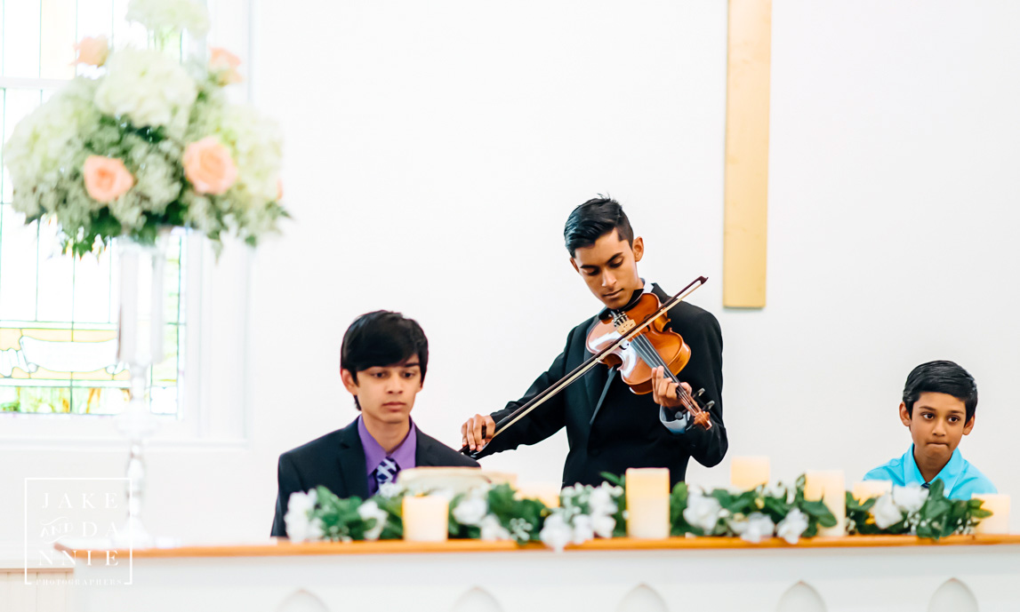 Musicians play in the chapel before the wedding ceremony.
