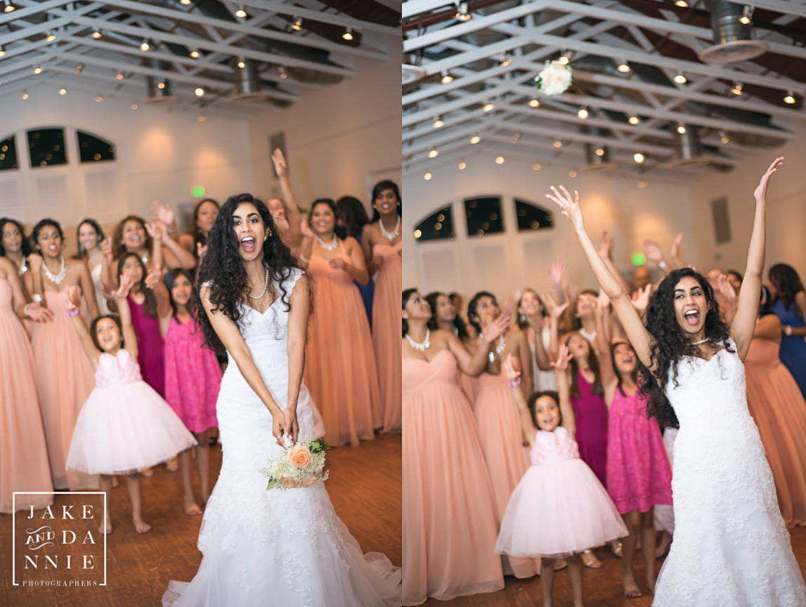 The bride throws the bouquet to the women behind her.