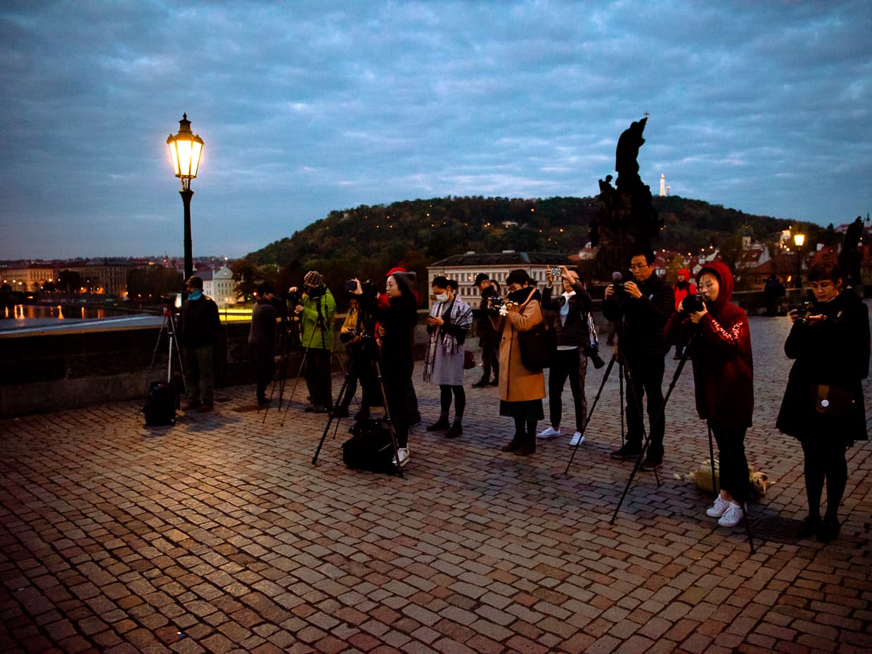 A wall of Chinese photographers in Prague on the Charles Bridge.