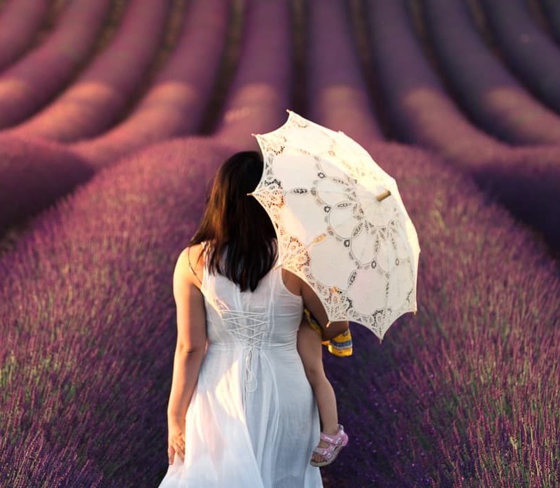 Walking in a Provence lavender field with a white dress and parasol.