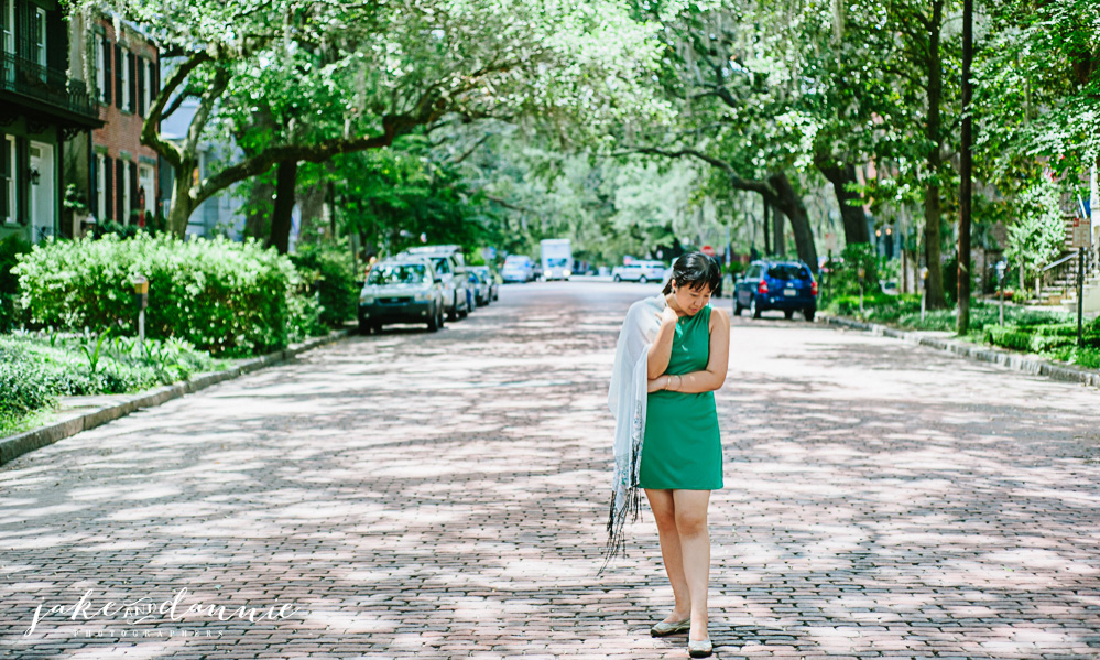 Dannie walks down a shady path and strikes a fashion photography pose in Forsyth Park