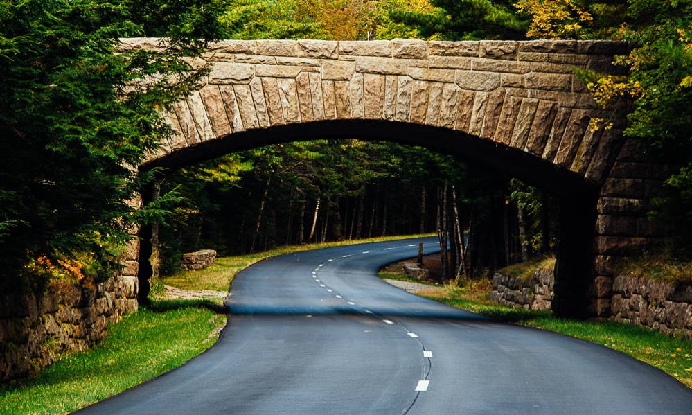 A stone bridge going over a road in Acadia national park in Maine