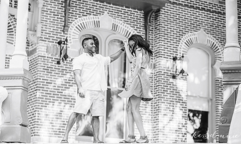 couple dancing on the steps of the Henry B Plant museum in Tampa, Florida during engagement photography session