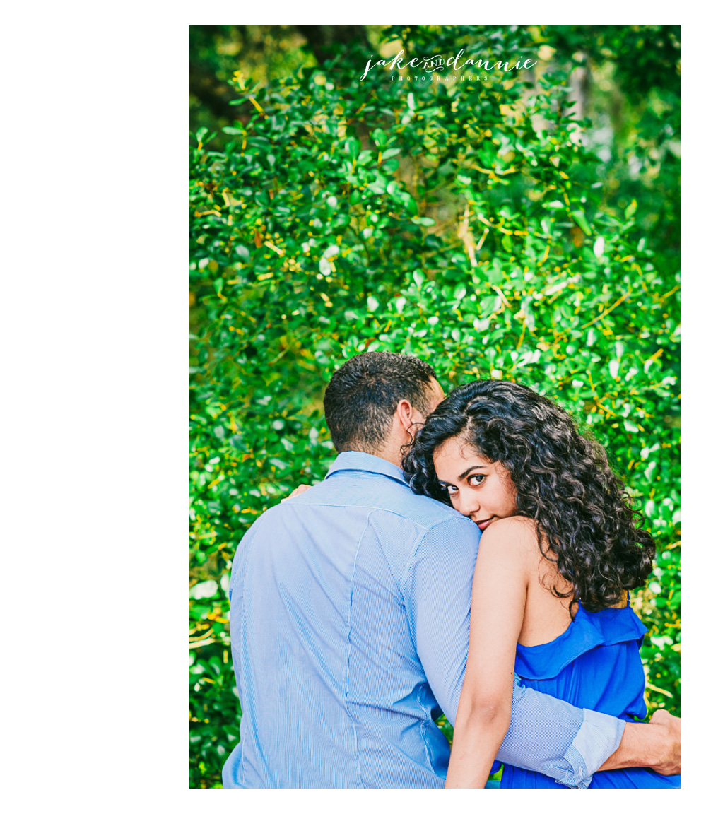 engaged couple lean on one another during photo session