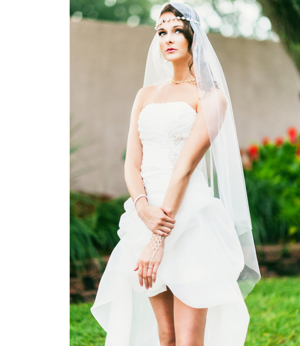A beautiful bride wears her wedding gown with a long veil