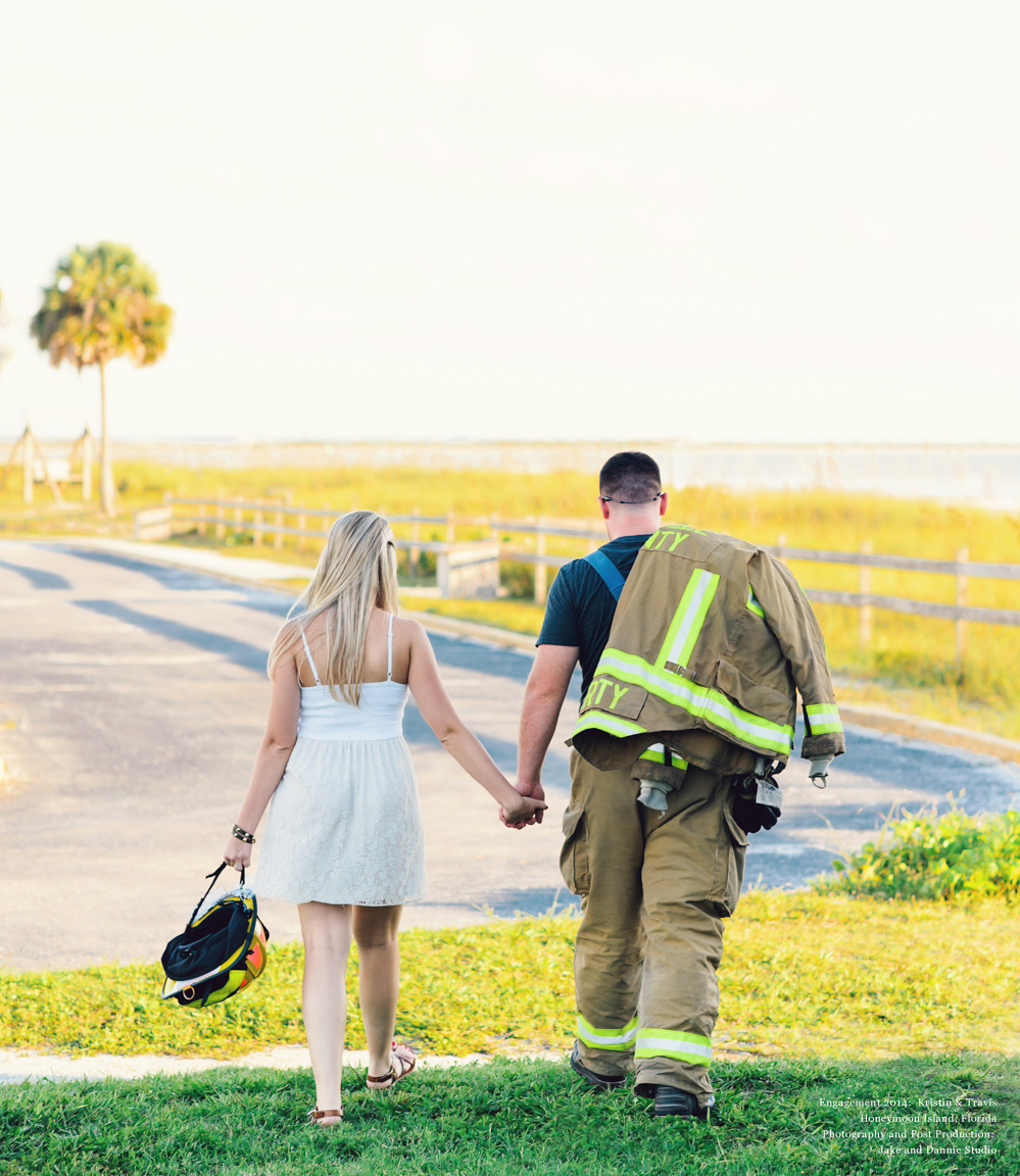 Fireman walks with future bride on Honeymoon Island in Florida