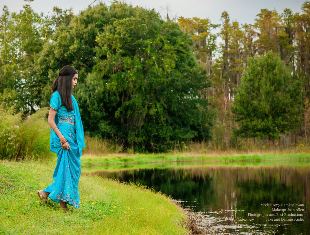 Beautiful woman walks toward water in blue dress